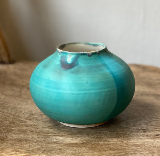 Turquoise blue curve vessel with glaze detail at brim